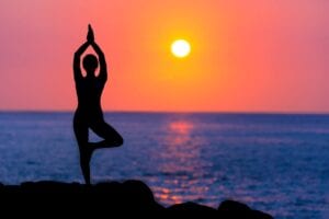 A Girl Doing Yoga Asana During Sunrise