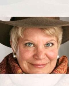 Woman wearing a brown hat and scarf.