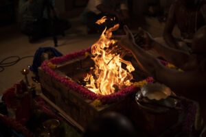Fire ritual with flames and offerings.